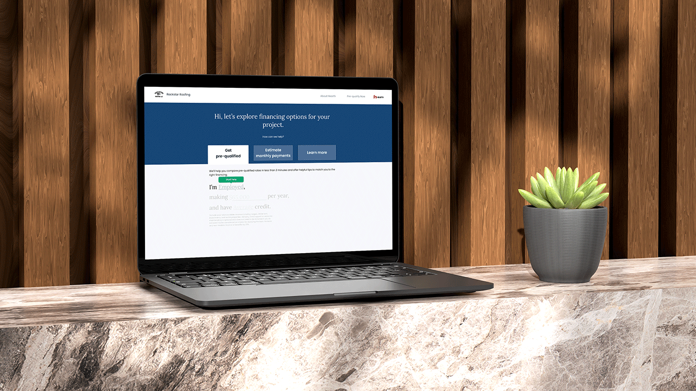 Laptop sitting on stone wall with Hearth financing tool on screen